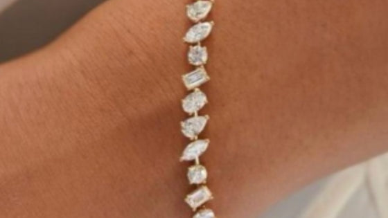 Line bracelet of mixed fancy-cut white gemstones in yellow gold worn on the wrist, photographed at Sapphire Row