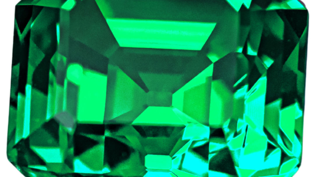 Vivid, slightly bluish green emerald in a step (emerald) cut, photographed on a light gray background