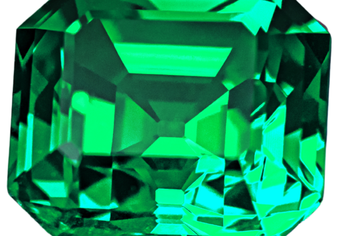 Vivid, slightly bluish green emerald in a step (emerald) cut, photographed on a light gray background