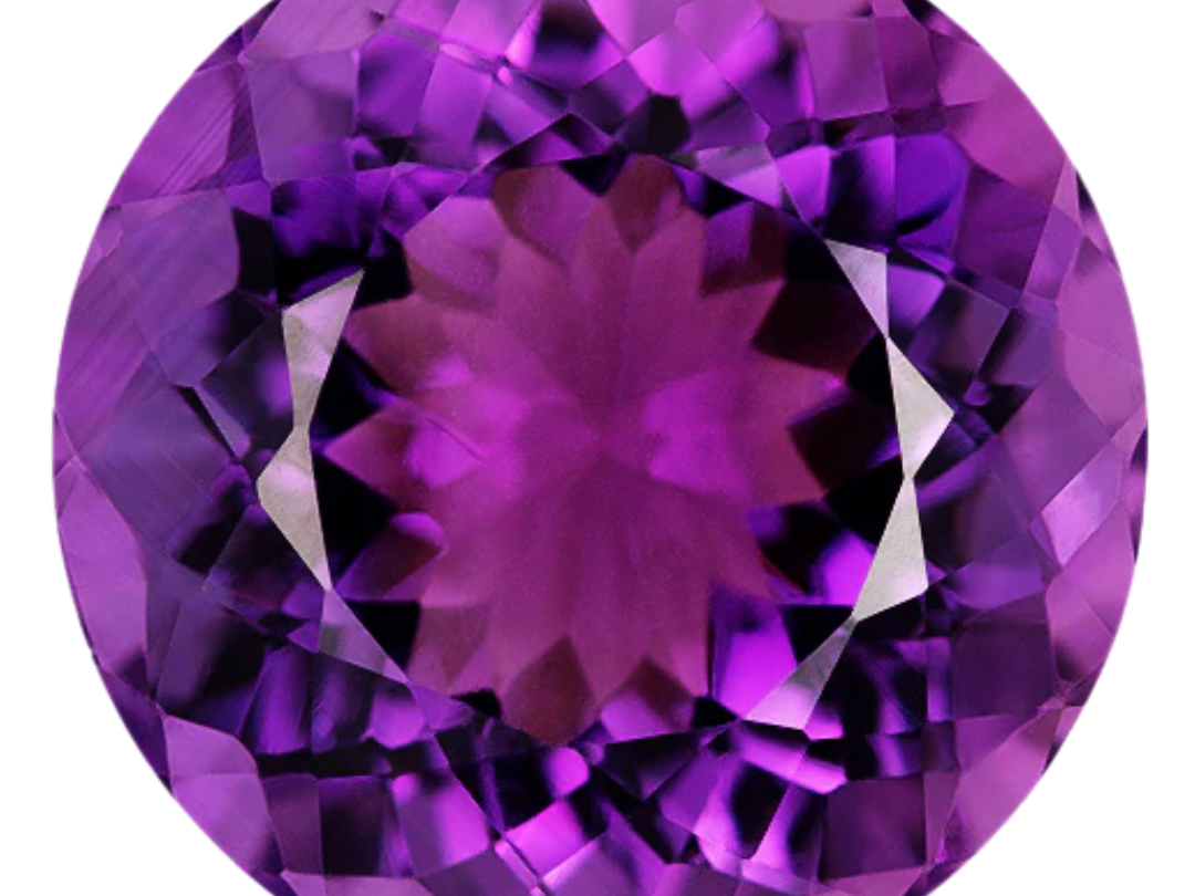 Round brilliant-cut amethyst in a vivid reddish purple with violet-purple flashes around the crown, photographed face-up on a pale gray background at Sapphire Row