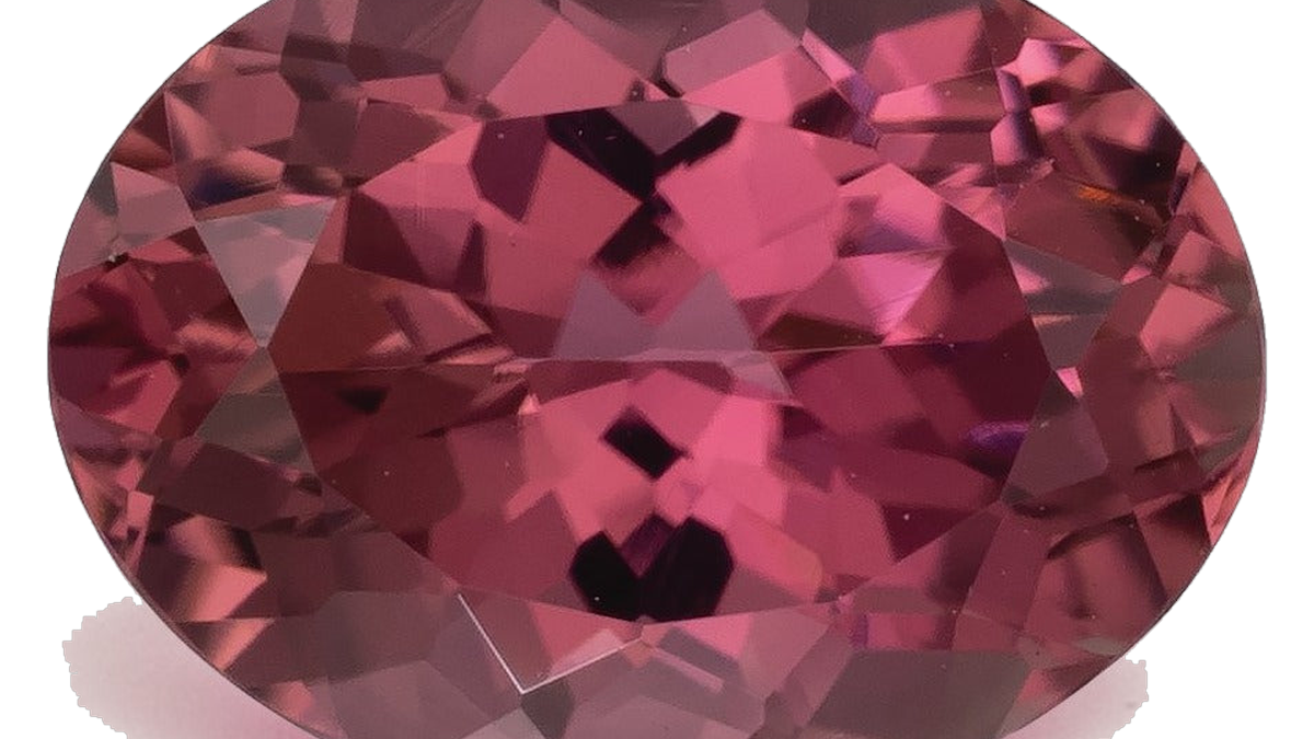 Oval mixed-cut natural pink tourmaline in a medium-dark slightly purplish pink with raspberry depth, photographed face-up on a pale gray background at Sapphire Row