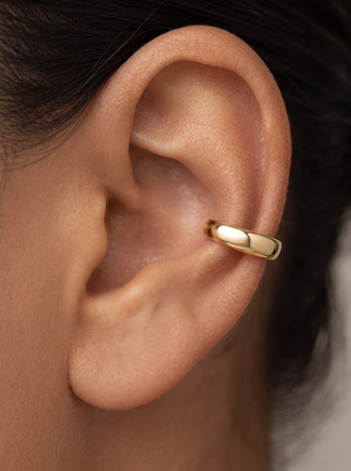 Gold Domed Ear Cuff in 10K Yellow Gold, shown close on the ear
