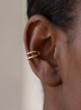 Gold Negative-Space Ear Cuff in 14K Yellow Gold, shown close on the ear