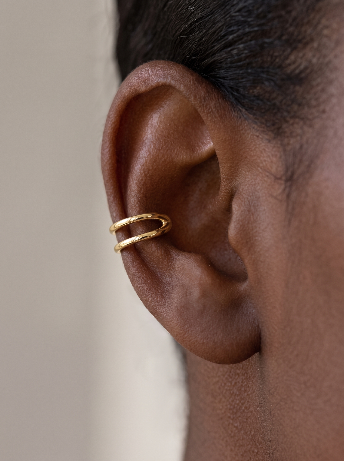 Gold Negative-Space Ear Cuff in 14K Yellow Gold, shown close on the ear