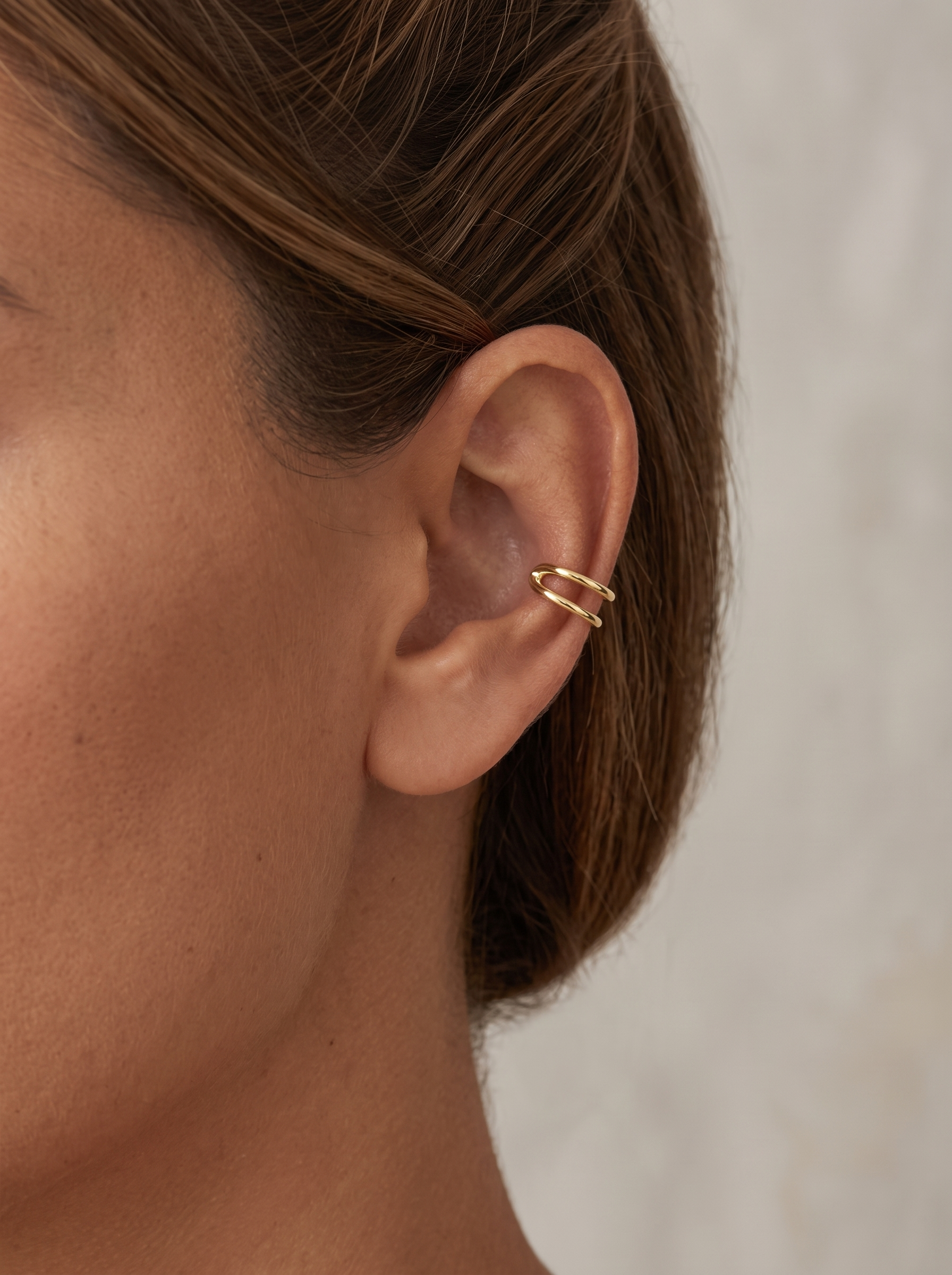 Gold Negative-Space Ear Cuff in 14K Yellow Gold, worn on the ear