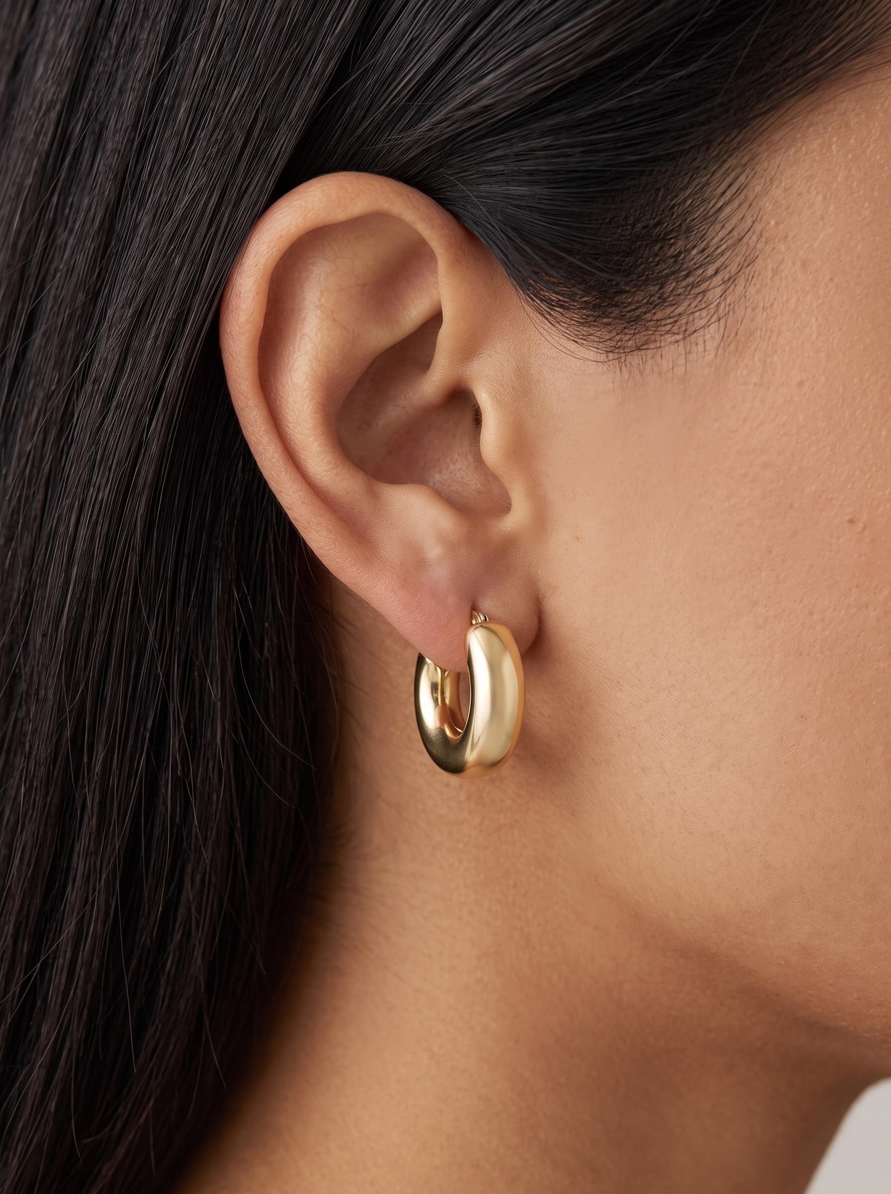 Gold Puffed Huggie Earrings in 14K Yellow Gold, worn on the ear