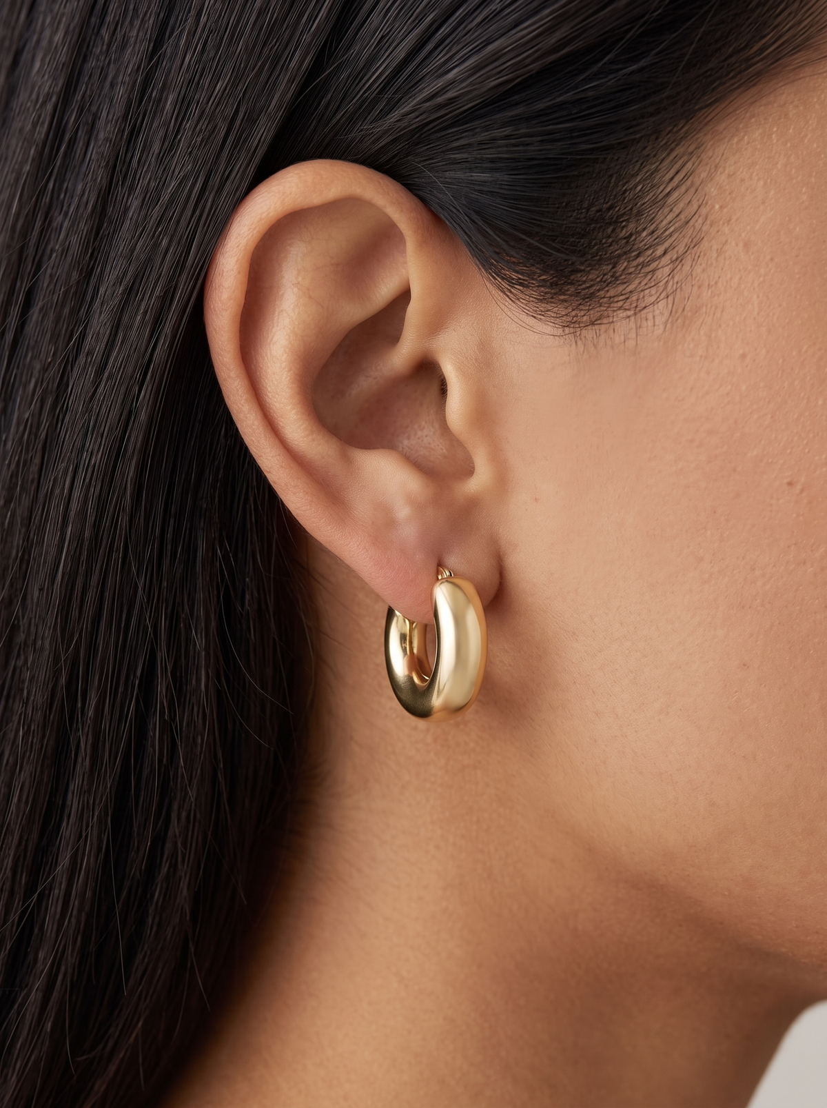 Gold Puffed Huggie Earrings in 14K Yellow Gold, worn on the ear