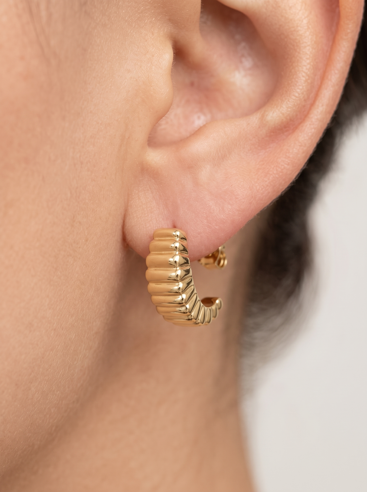 Gold Puffed J-Hoop Earrings in 14K Yellow Gold, shown close on the ear