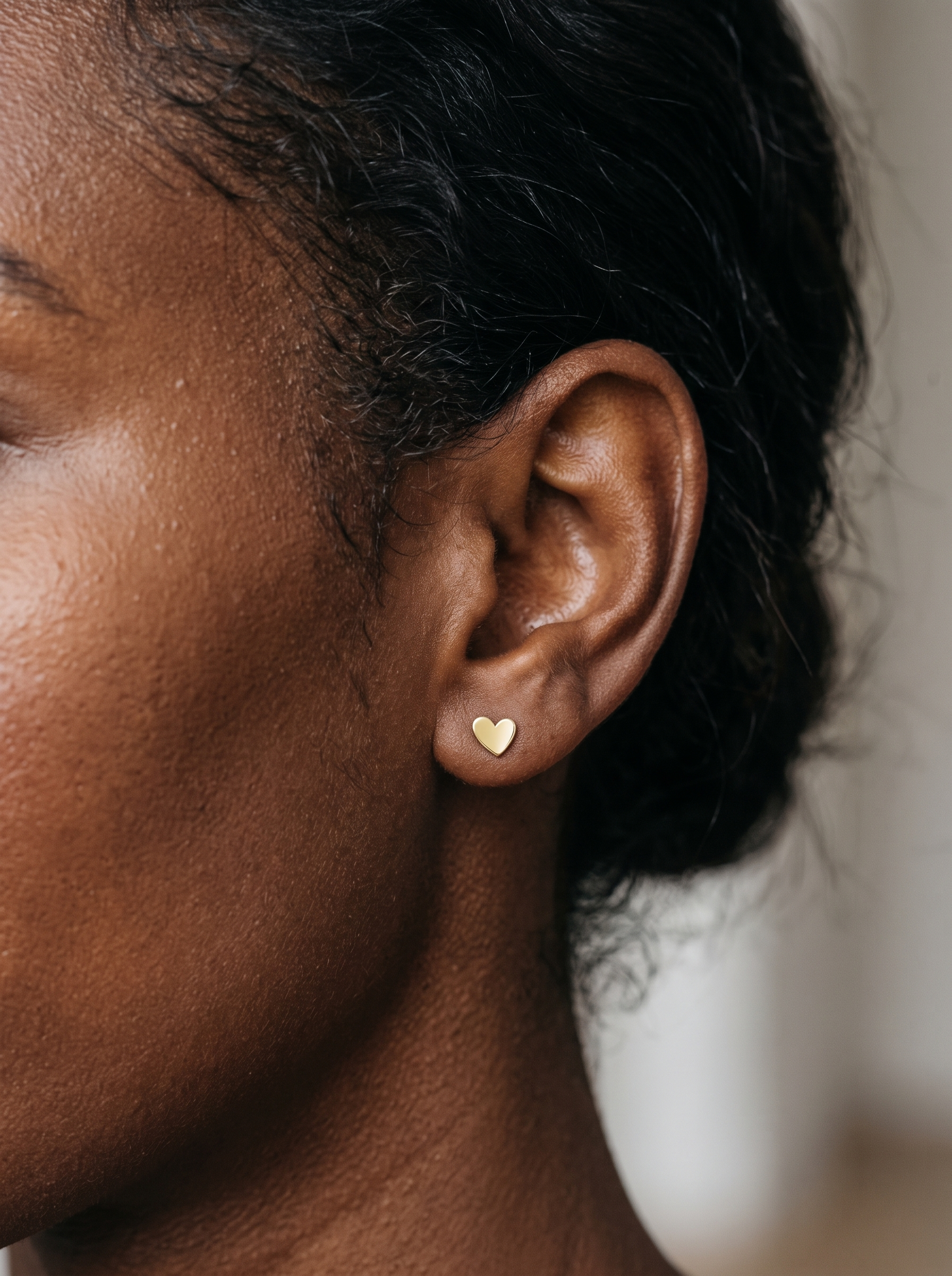 Gold Sweetheart Heart Stud Earrings in 14K Yellow Gold, worn on the ear
