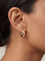 Gold Thick Huggie Earrings in 10K Yellow Gold, worn on the ear