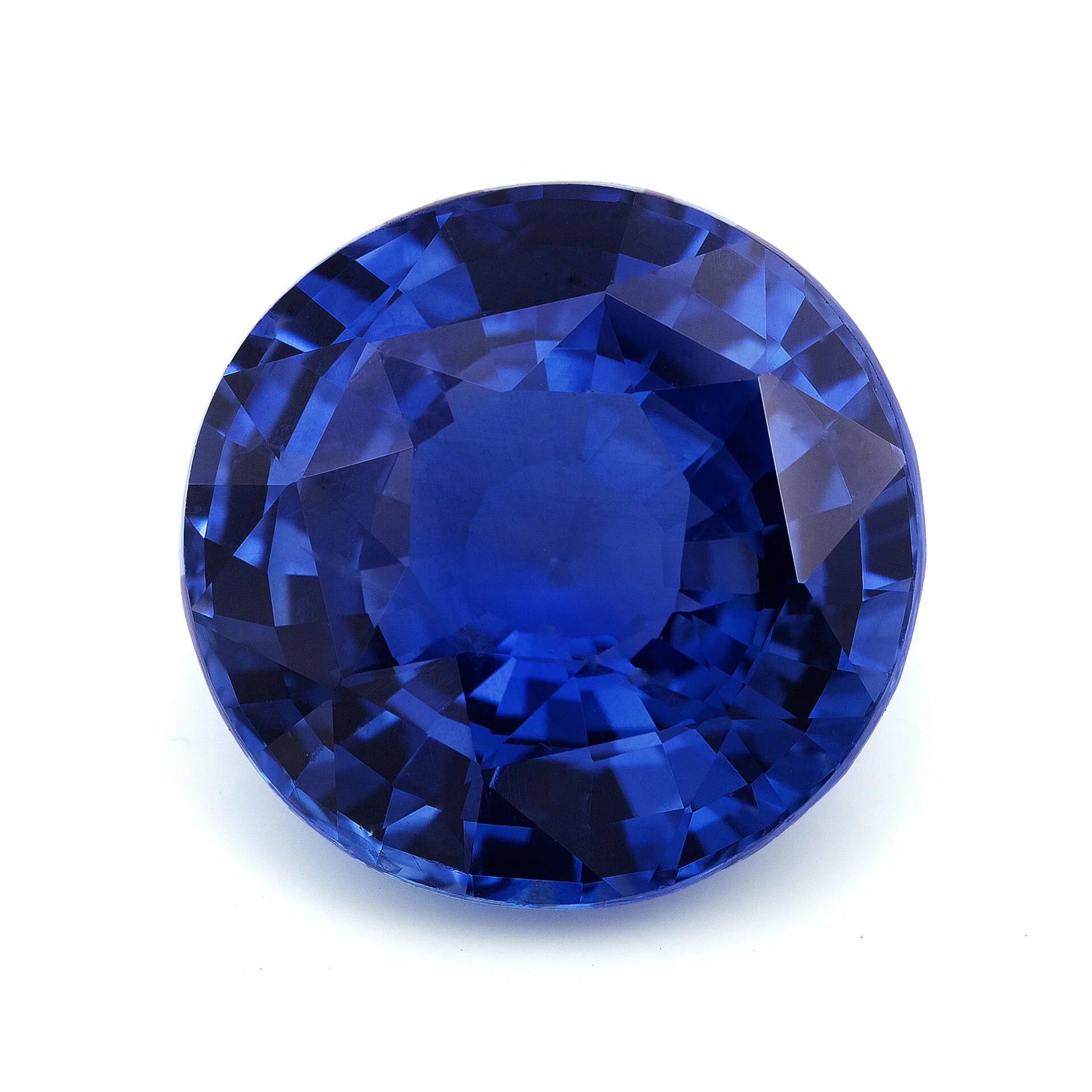 Faceted oval blue sapphire gemstone on white background