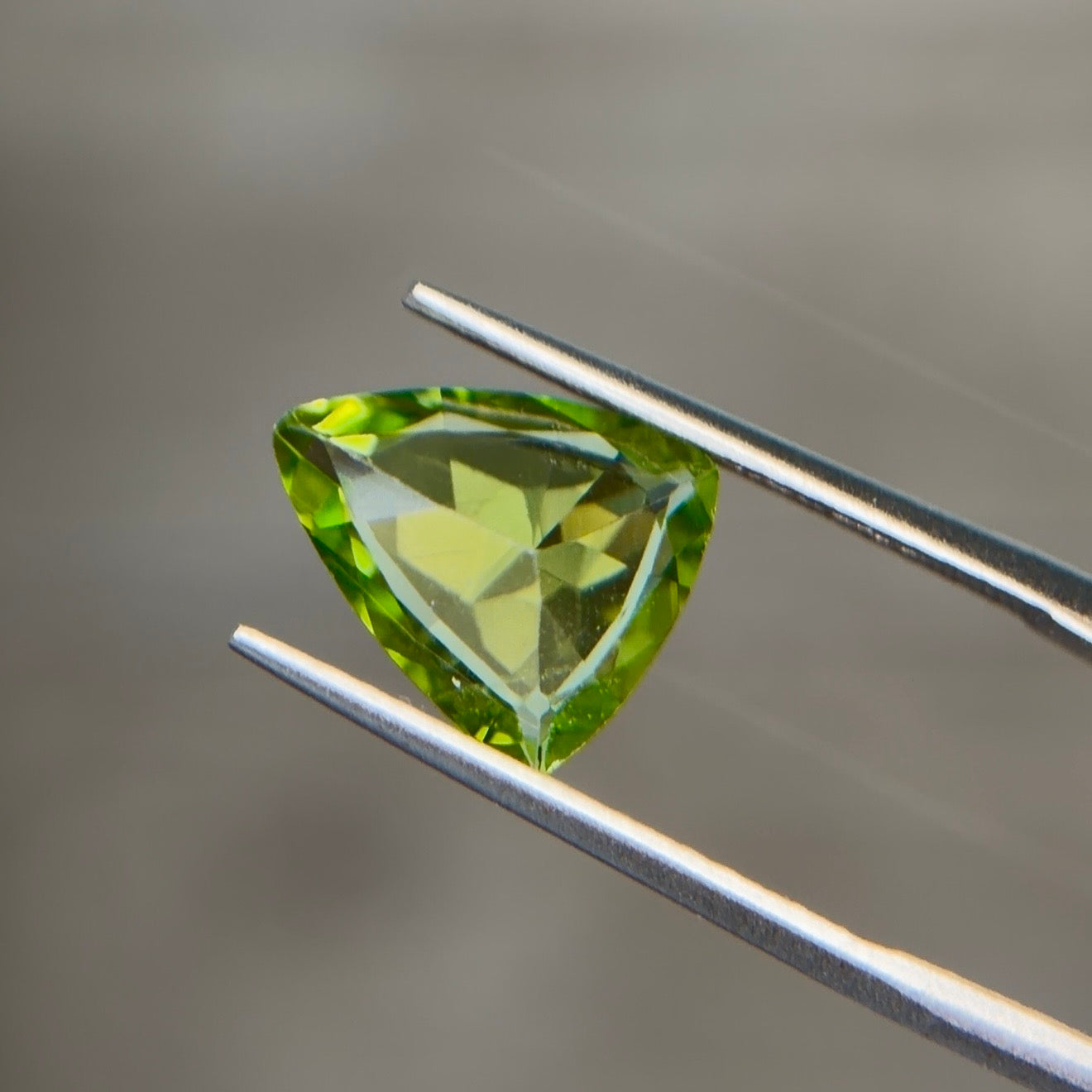 2.46 ct Natural Peridot Olive Green – Trillion Cut – AIG Certified