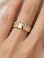 Natural Diamond Cigar Band in 14K Yellow Gold, worn on the finger, close detail of the staggered diamond edge