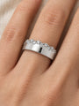 Natural Diamond Cigar Band in 14K White Gold, worn on the finger against ivory linen with staggered diamonds along the edge