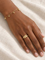 Gold Bead Station Bracelet in 14K Yellow Gold, shown close at the wrist, five polished bead drops, with a domed bypass ring
