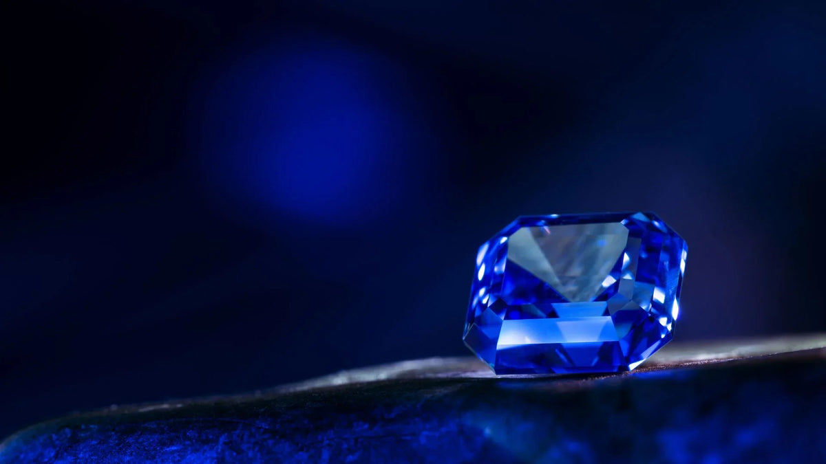 Vivid blue faceted gemstone on dark background, showcasing clarity and brilliance