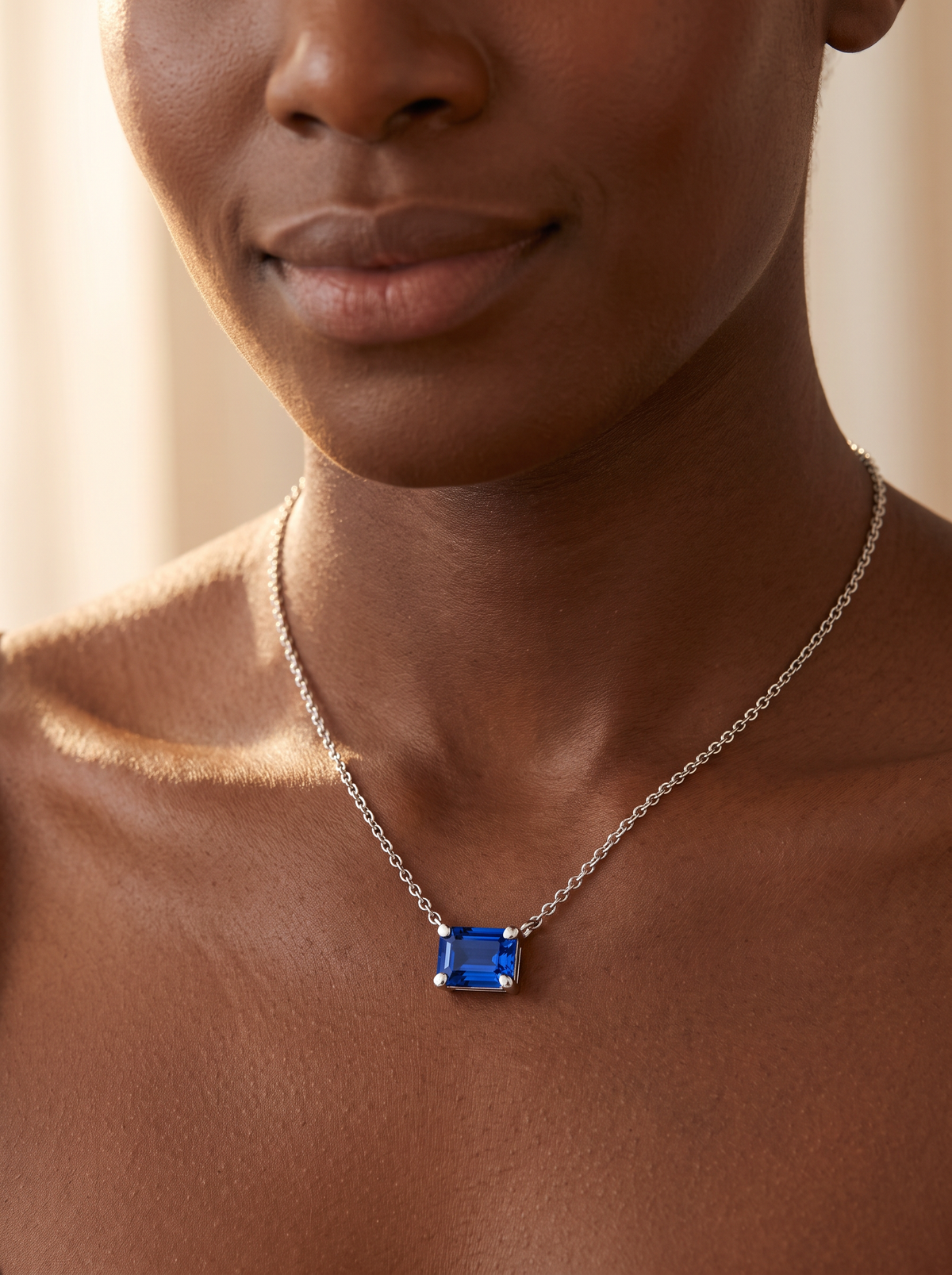 Lab-Grown Emerald-Cut Gemstone Necklace in Platinum, Blue Sapphire, shown close at the collarbone