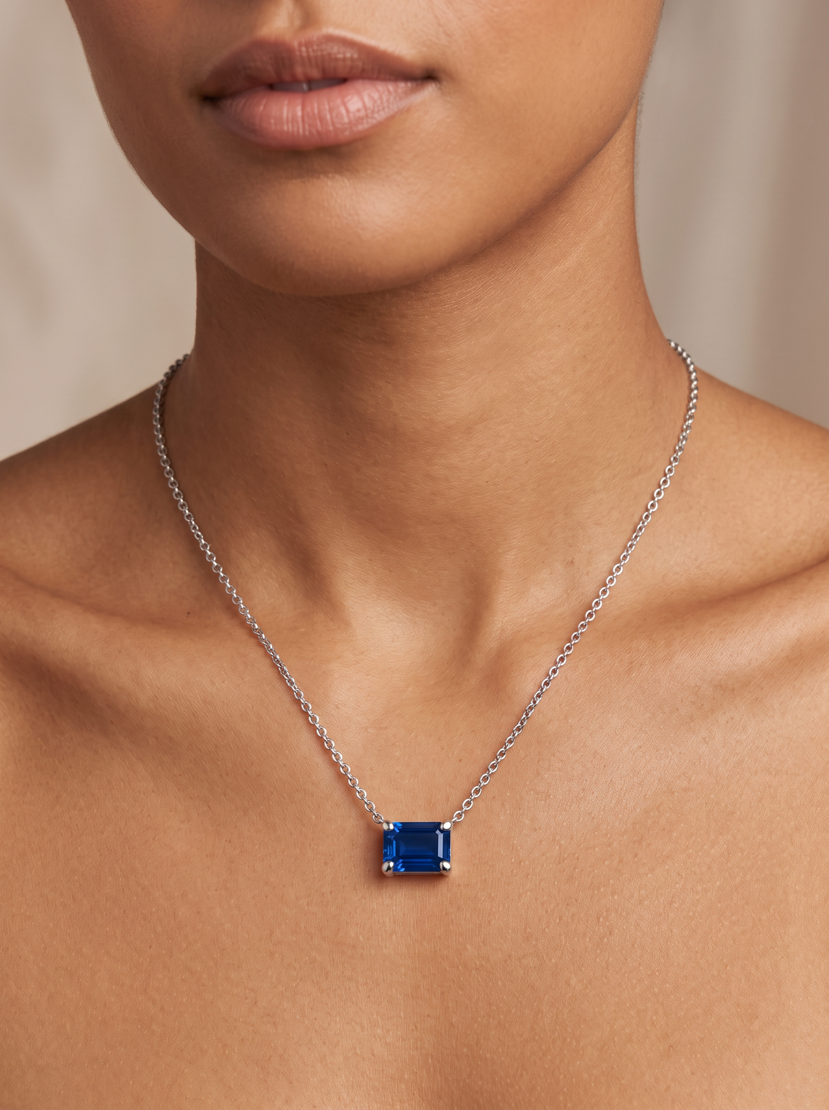 Lab-Grown Emerald-Cut Gemstone Necklace in Platinum, Blue Sapphire, worn at the collarbone