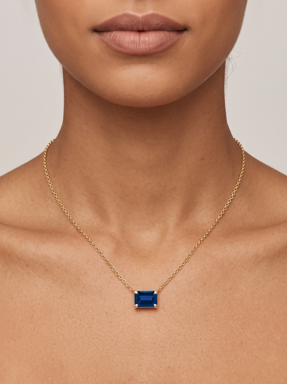 Lab-Grown Emerald-Cut Gemstone Necklace in 14K Yellow Gold, Blue Sapphire, worn at the collarbone