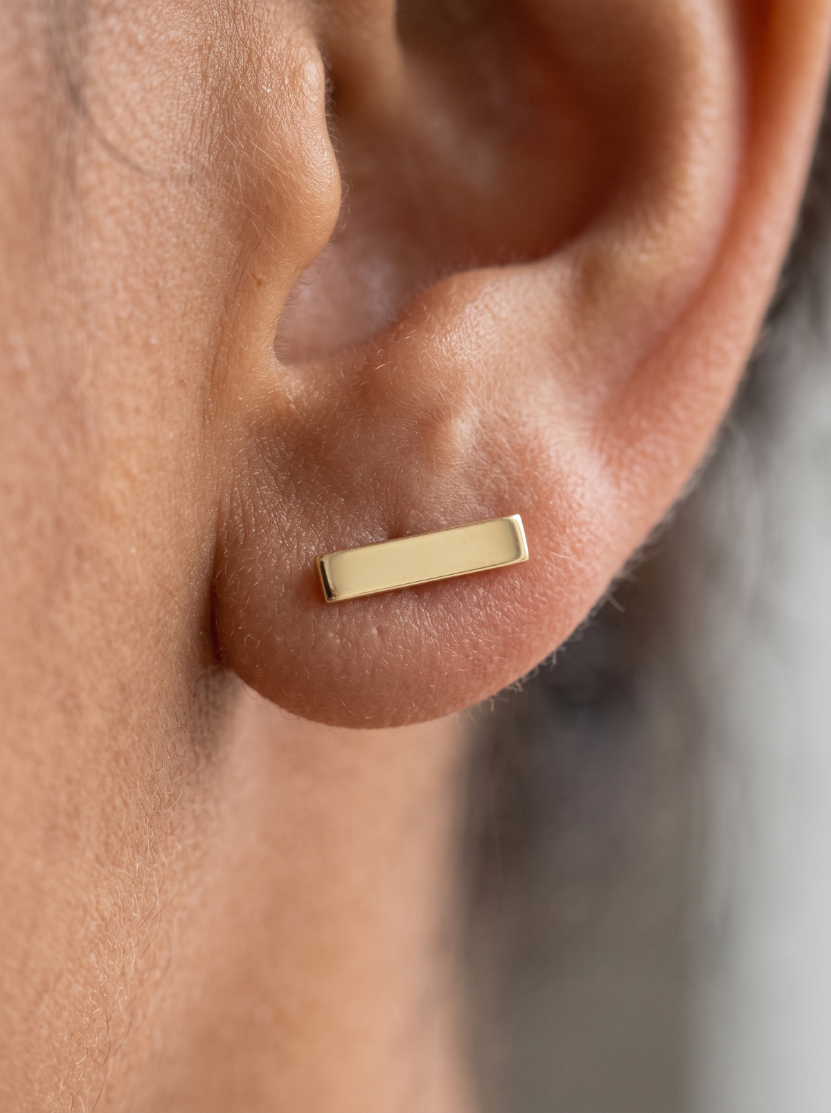 Engravable Bar Earrings in 14K Yellow Gold, shown close on the ear