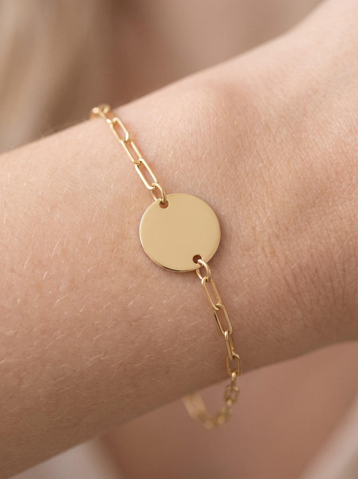 Engravable Disc Bracelet in 10K Yellow Gold, shown close on the wrist