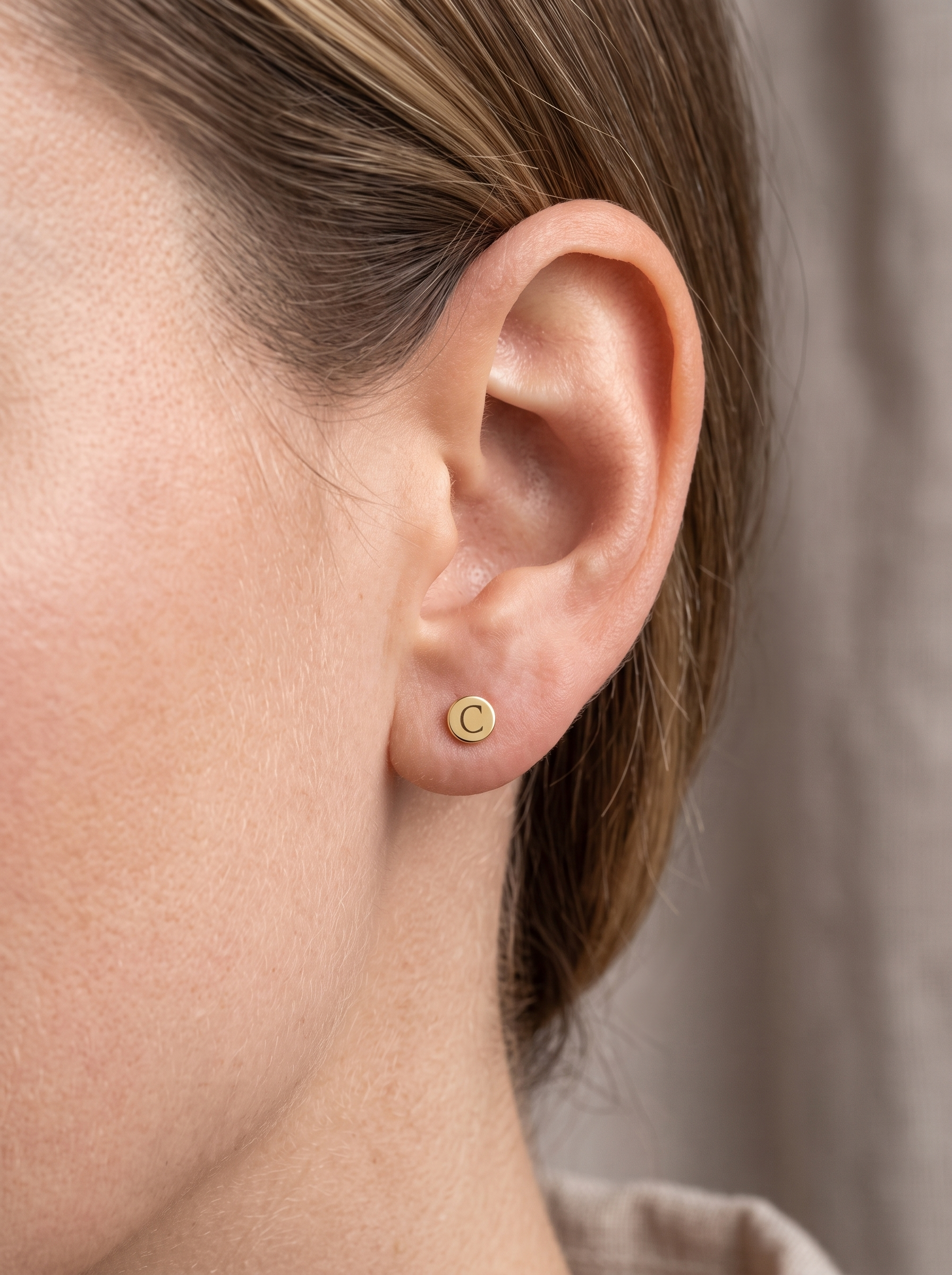 Engravable Gold Disc Stud Earrings in 14K Yellow Gold, worn on the ear