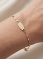 Engravable Keyhole Bracelet in 14K Yellow Gold, shown close on the wrist