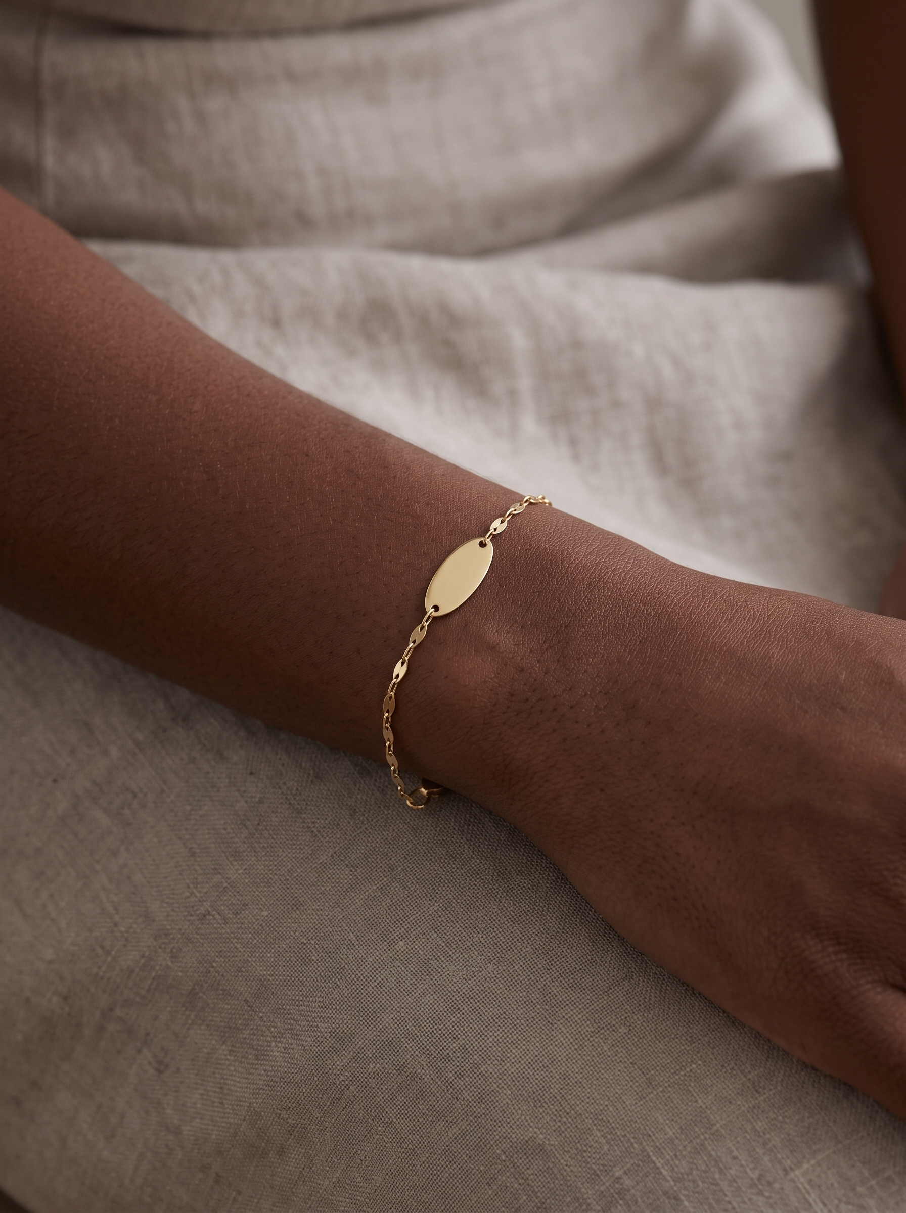 Engravable Keyhole Bracelet in 14K Yellow Gold, worn on the wrist