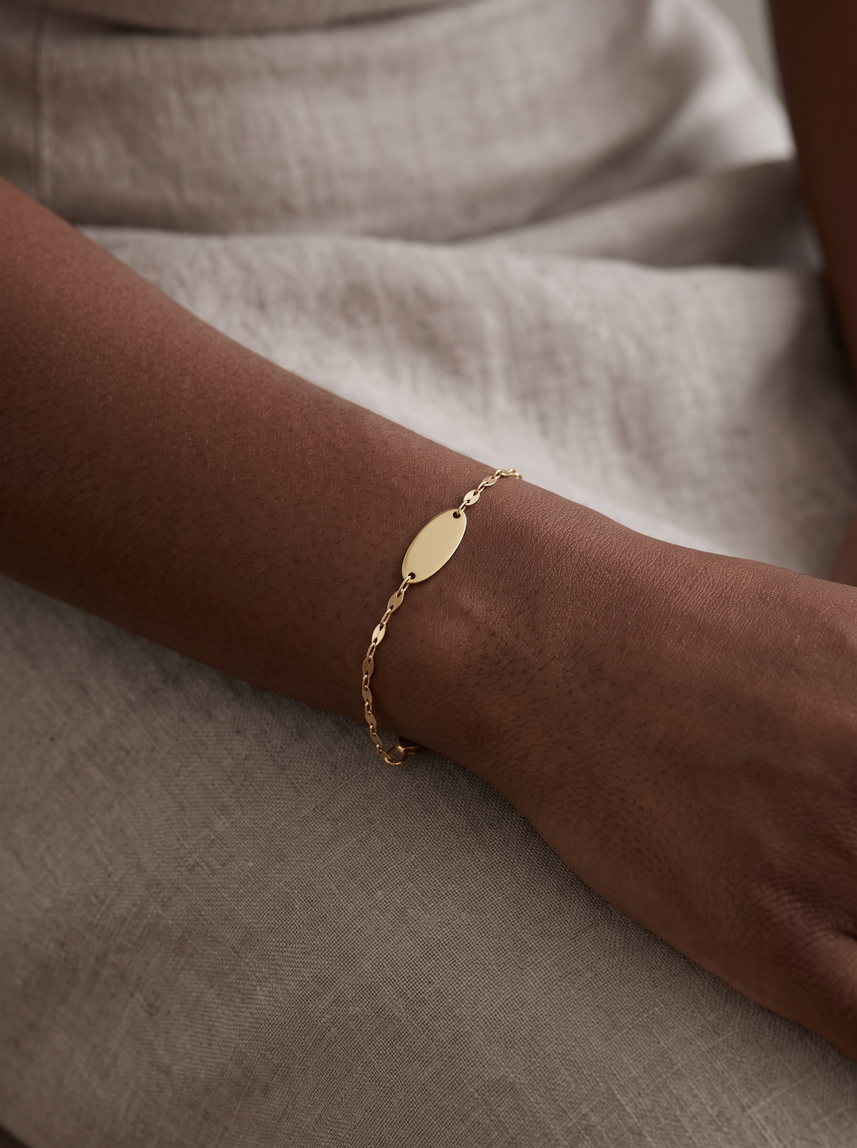 Engravable Keyhole Bracelet in 14K Yellow Gold, worn on the wrist