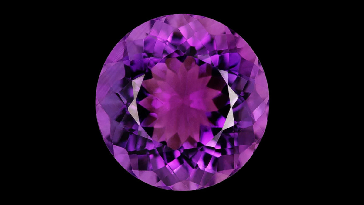 Round violet amethyst gemstone on a black background