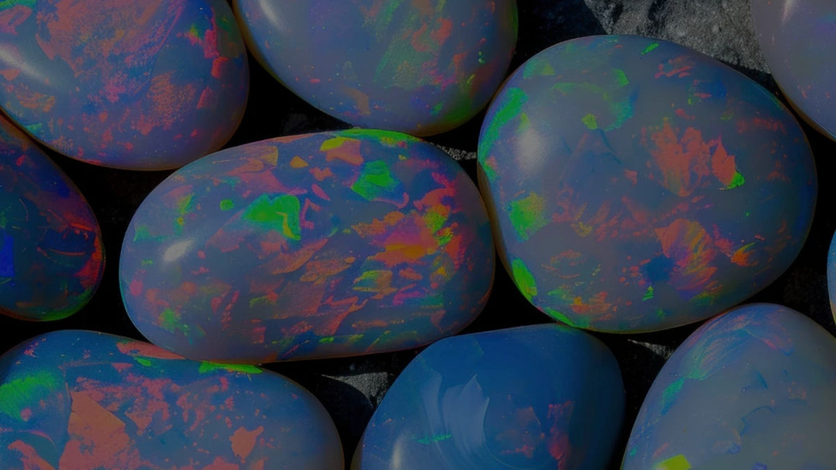 Polished opals with vivid play-of-color on a dark background