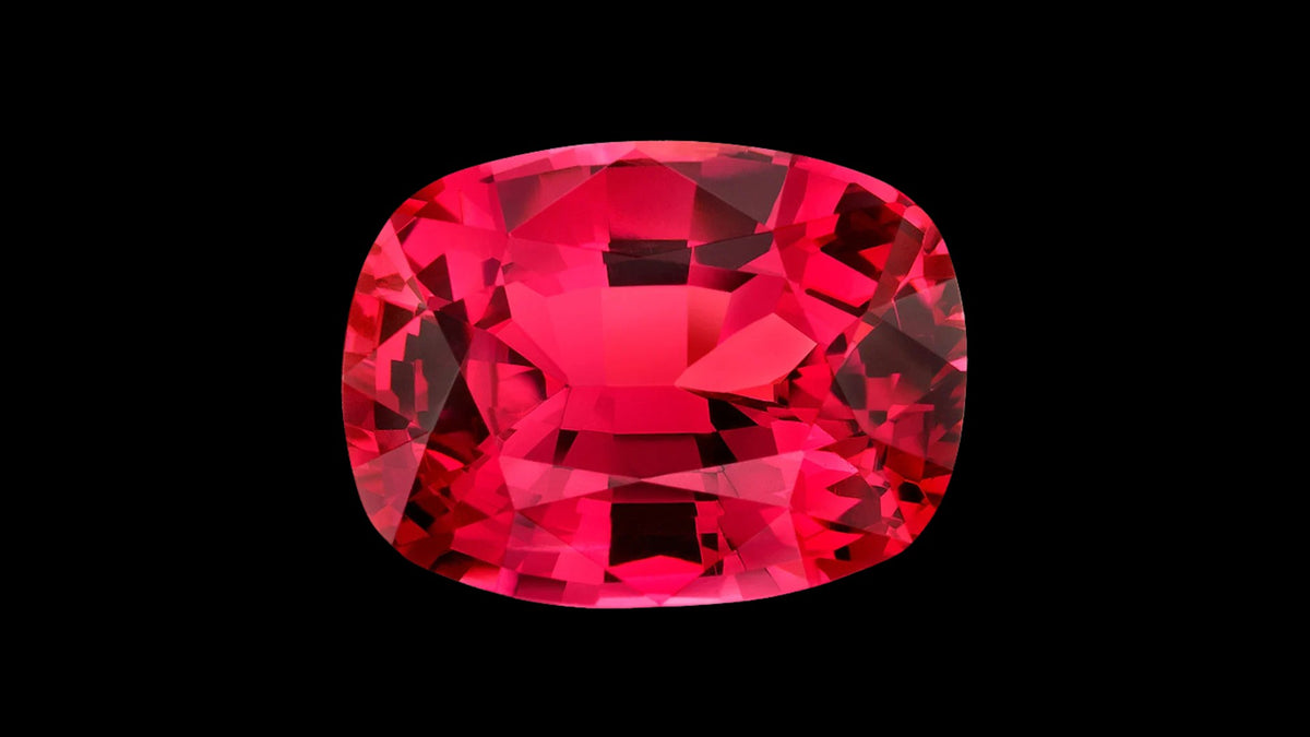 Cushion-cut red spinel gemstone on a black background
