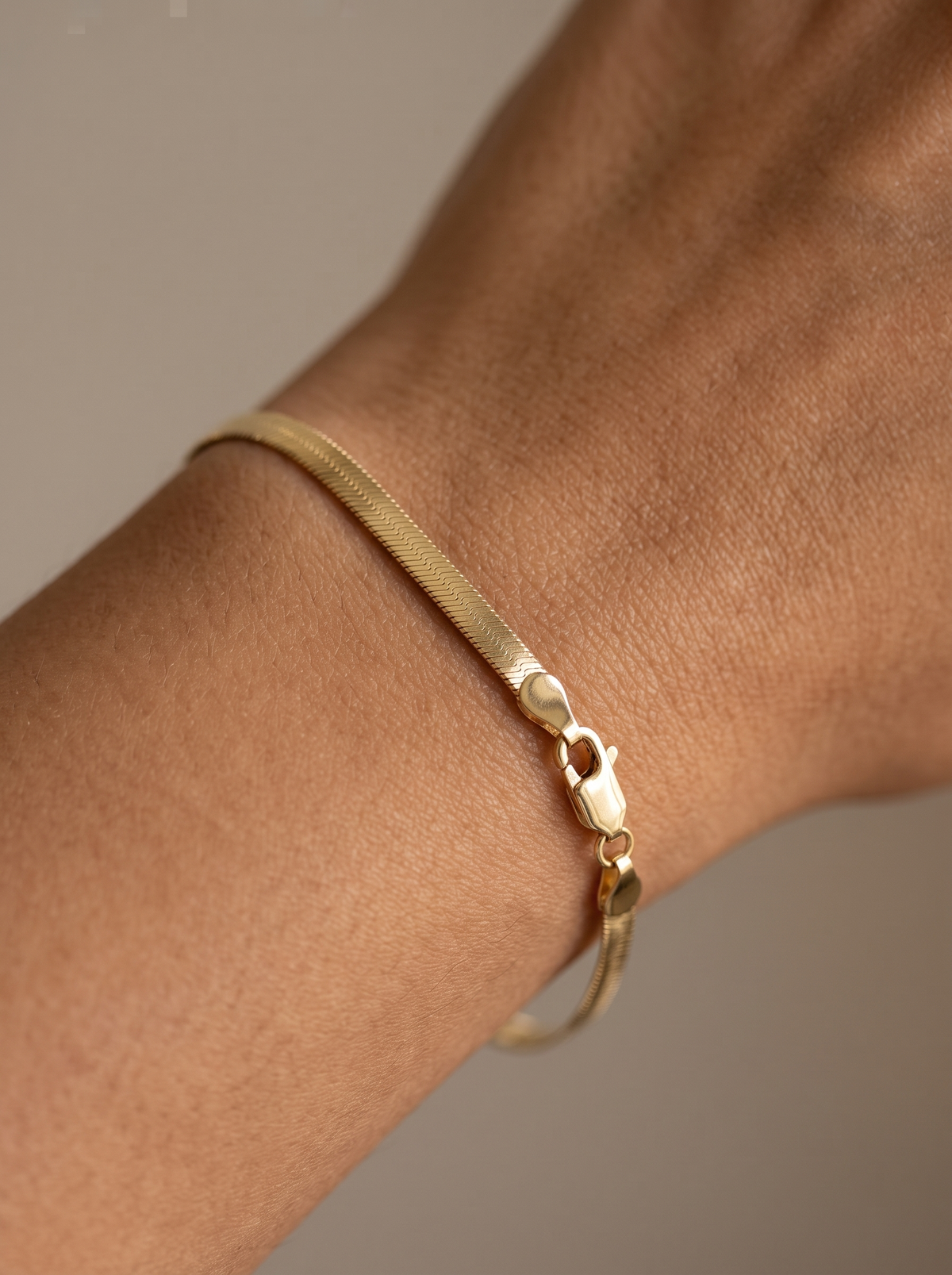 Herringbone Chain Bracelet in 14K Yellow Gold, shown close on the wrist