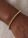 Hollow Bead Chain Bracelet in 14K Yellow Gold, shown close on the wrist
