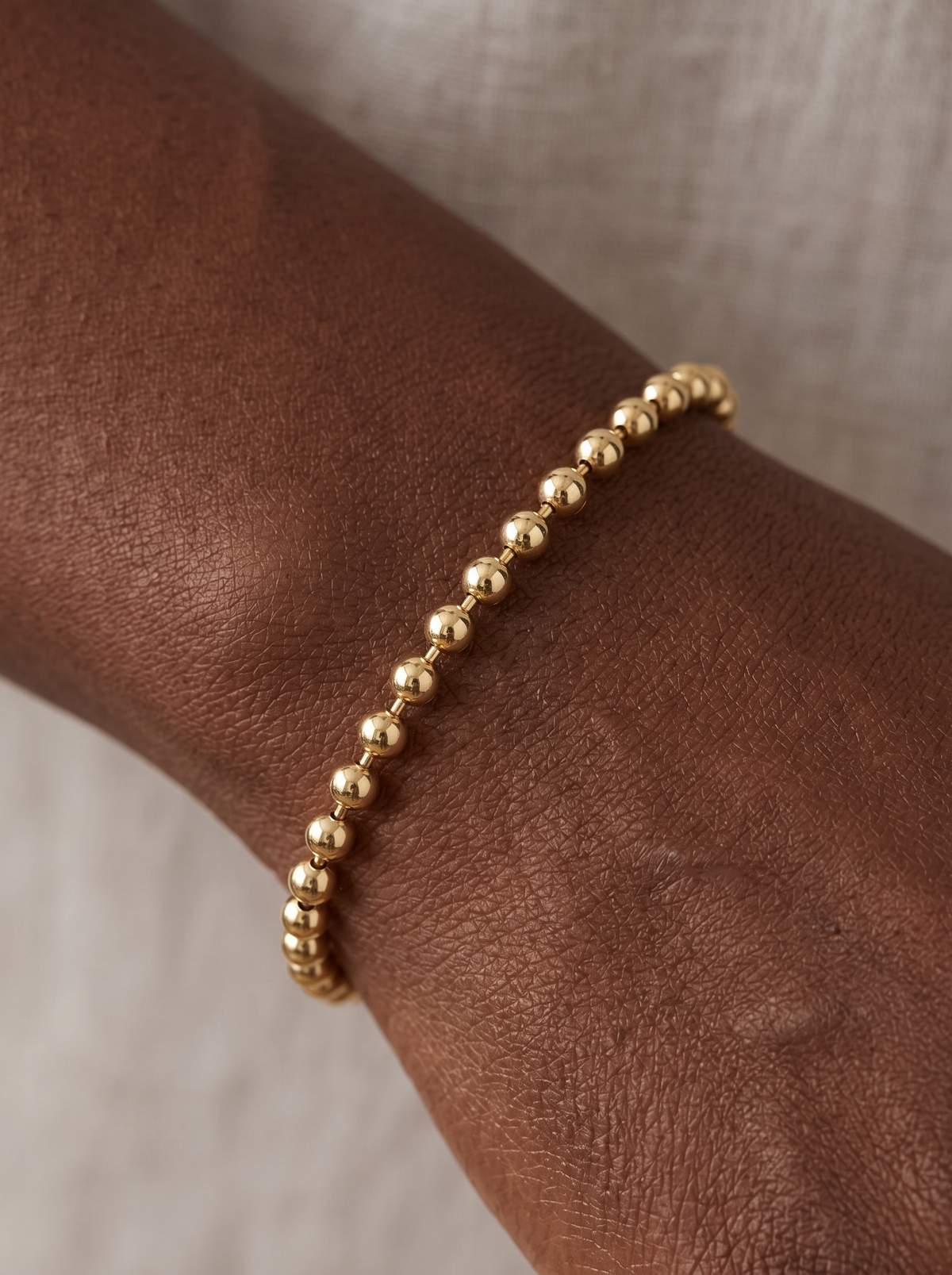 Hollow Bead Chain Bracelet in 14K Yellow Gold, shown close on the wrist