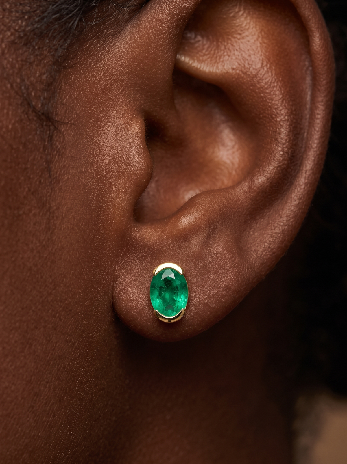 Lab-Grown Gemstone Half-Bezel Oval Stud Earrings in 14K Yellow Gold, shown close on the ear