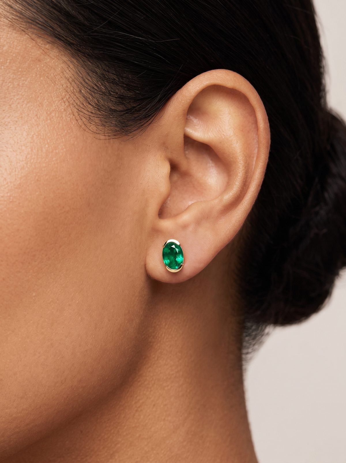 Lab-Grown Gemstone Half-Bezel Oval Stud Earrings in 14K Yellow Gold, worn on the ear