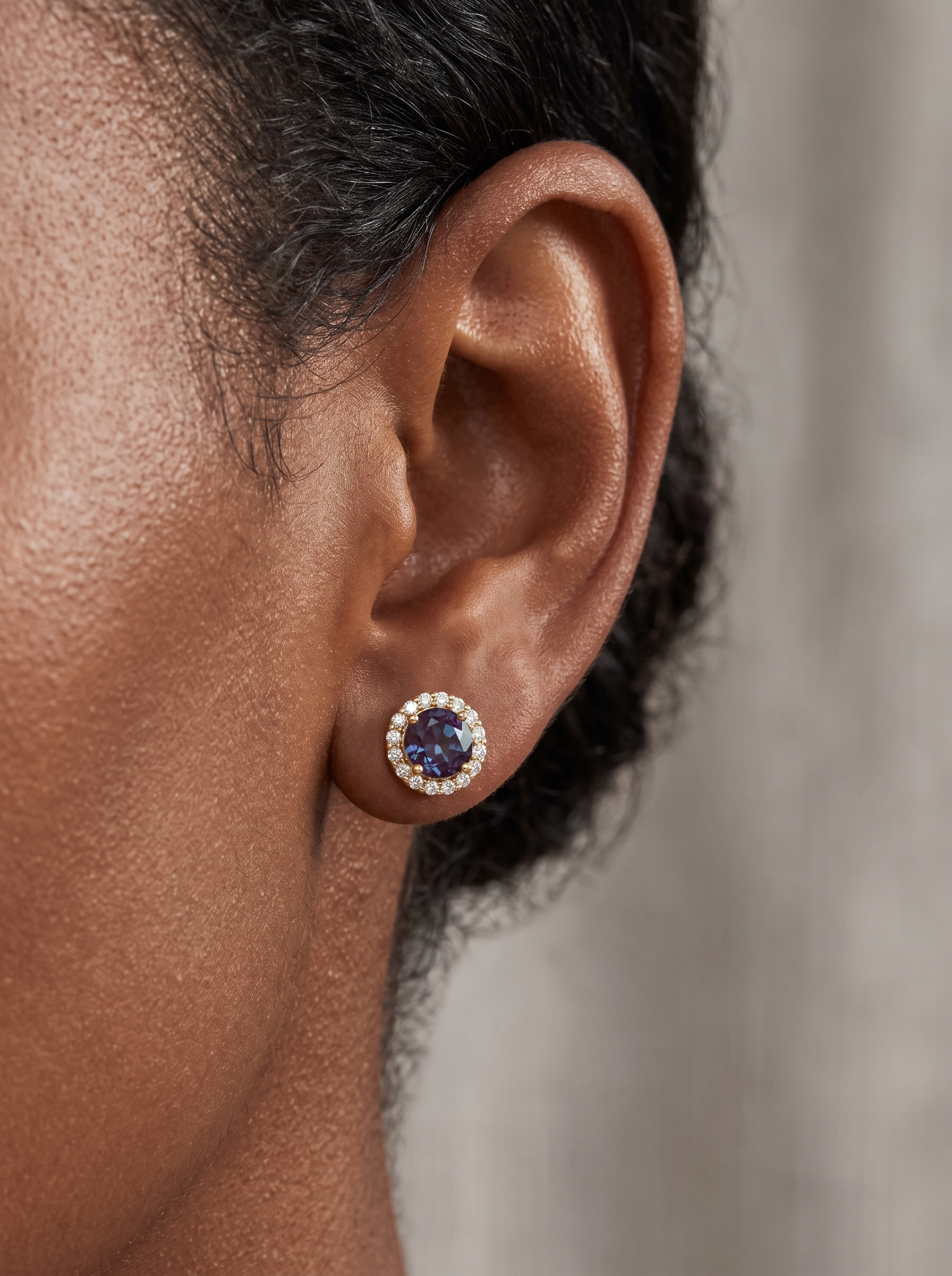 Lab-Grown Gemstone Halo Stud Earrings in 14K Yellow Gold, worn on the ear