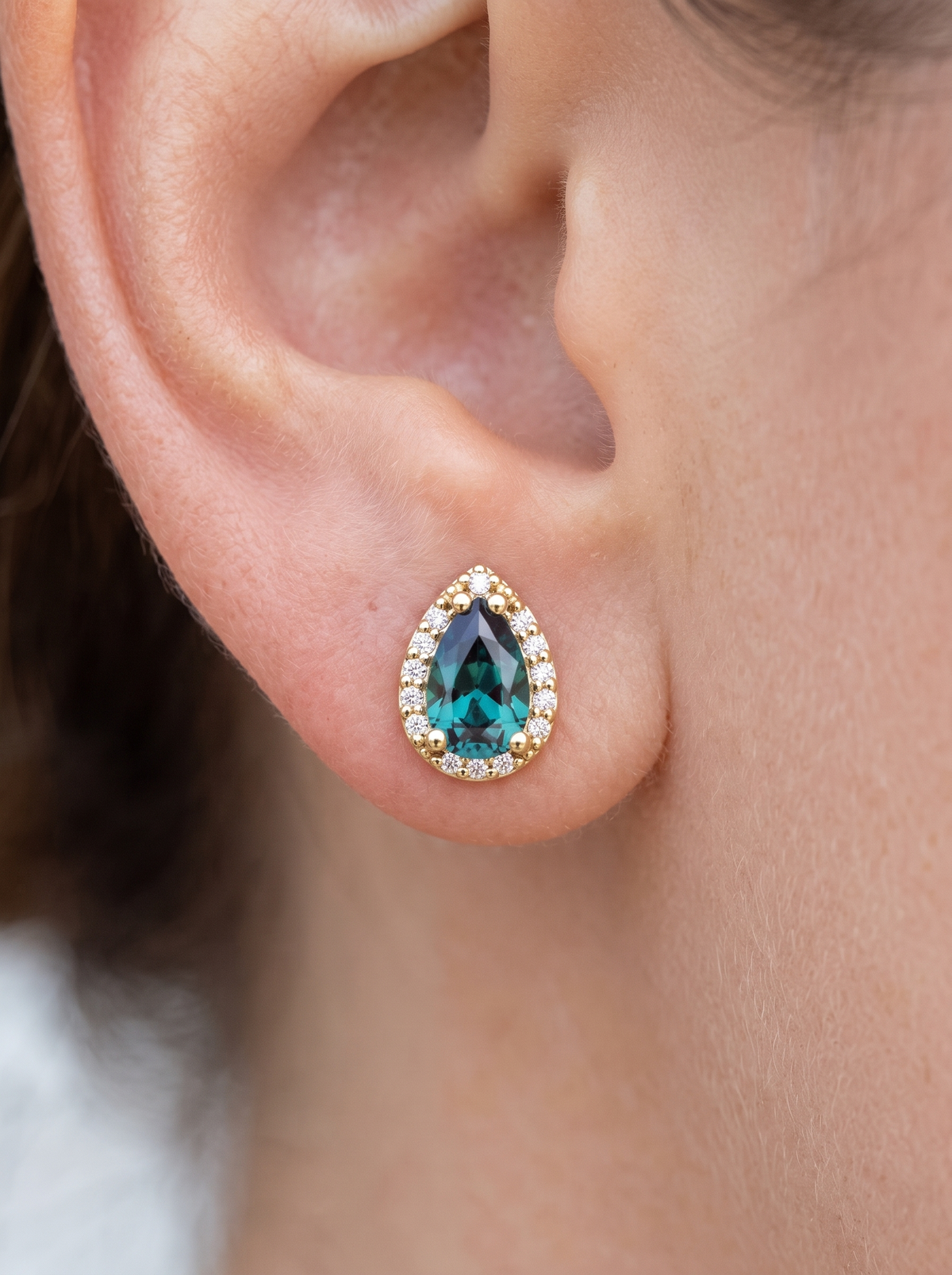 Lab-Grown Gemstone Pear Halo Stud Earrings in 14K Yellow Gold, shown close on the ear