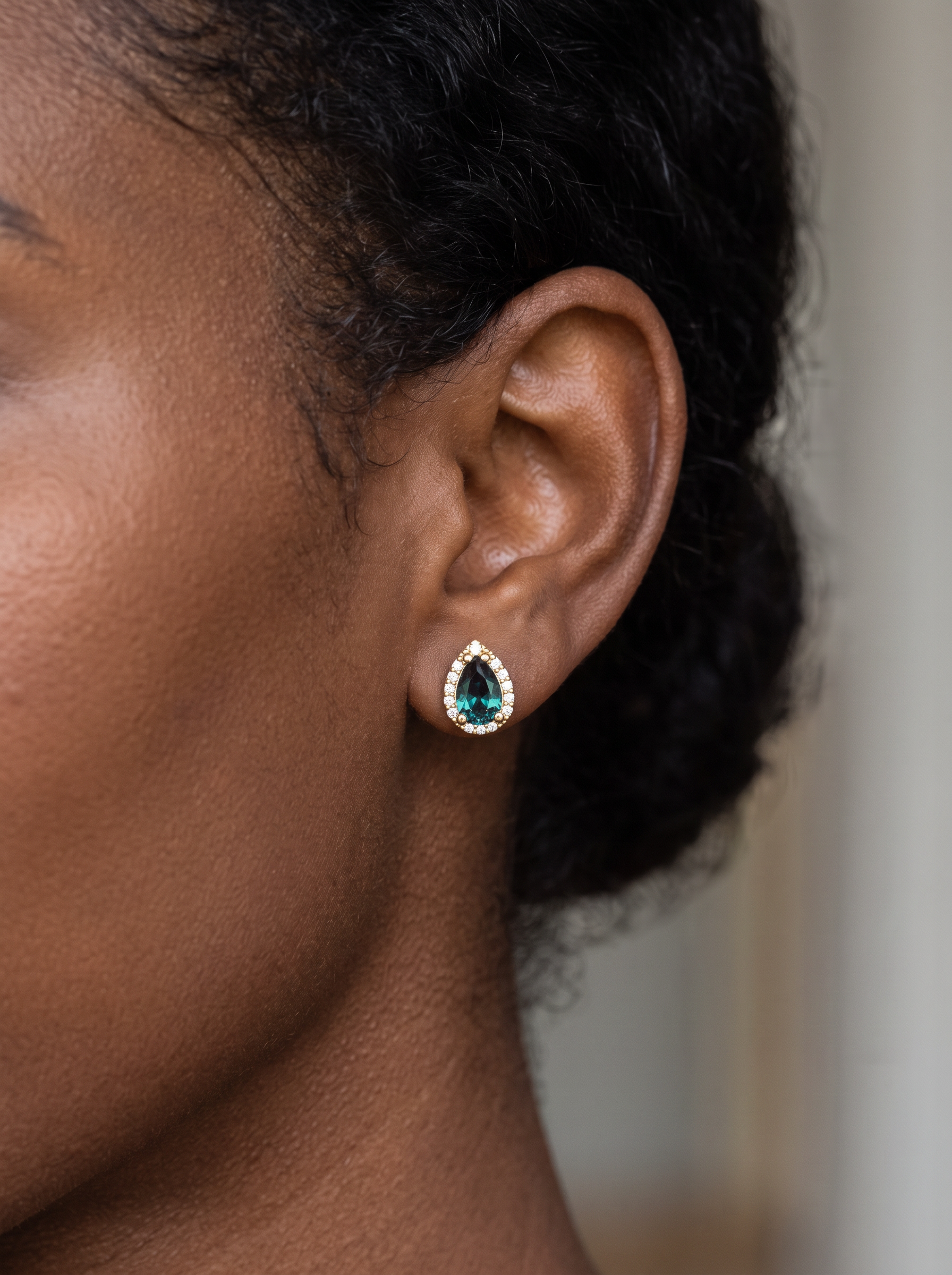 Lab-Grown Gemstone Pear Halo Stud Earrings in 14K Yellow Gold, worn on the ear