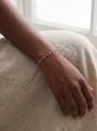 Natural Bezel-Set Gemstone Solitaire Bracelet in 14K Yellow Gold, worn on the wrist