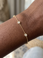 Natural Diamond Bezel Station Bracelet in 14K Yellow Gold, shown close on the wrist