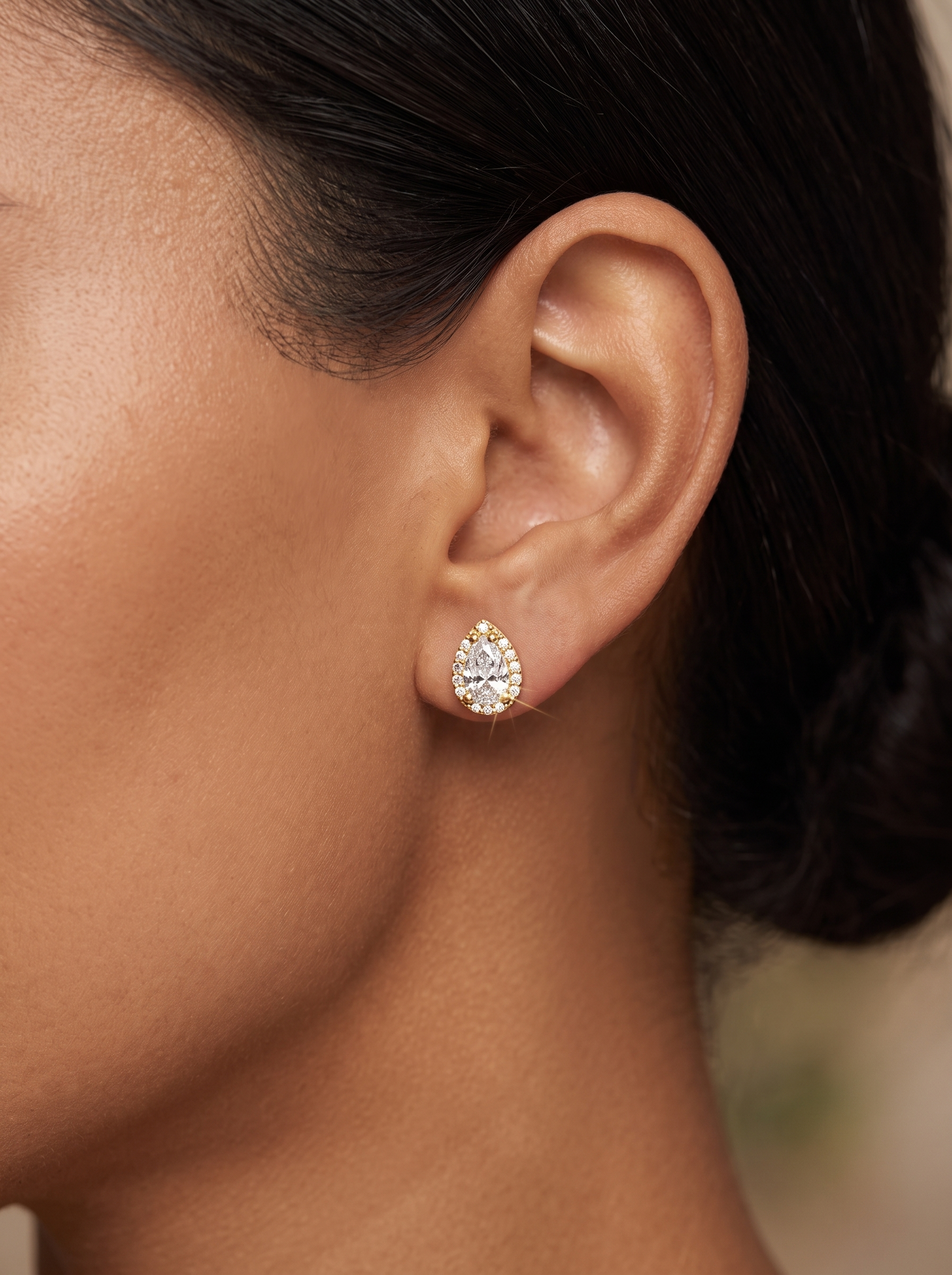 Natural Diamond Pear Halo Stud Earrings in 14K Yellow Gold, worn on the ear