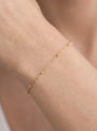 Satellite Bead Cable Bracelet in 10K Yellow Gold, shown close on the wrist