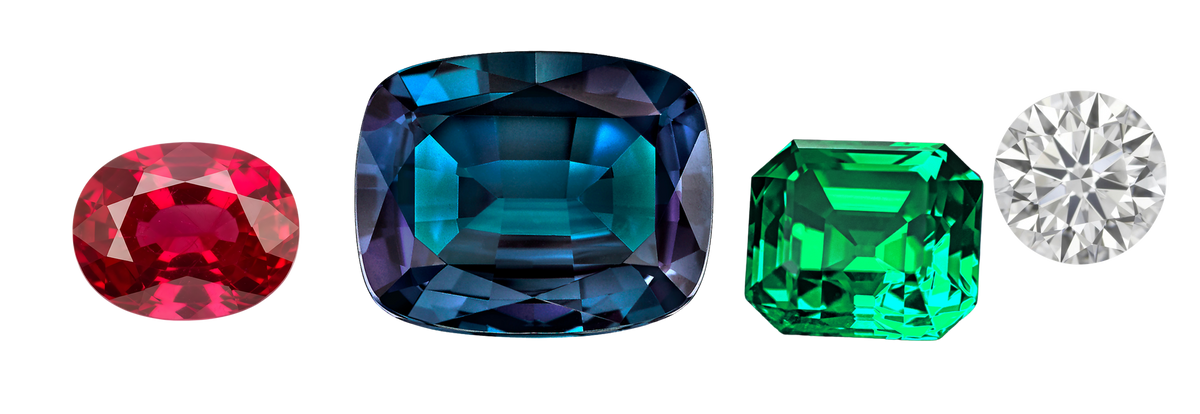 Loose faceted gemstones — ruby, alexandrite, emerald and diamond